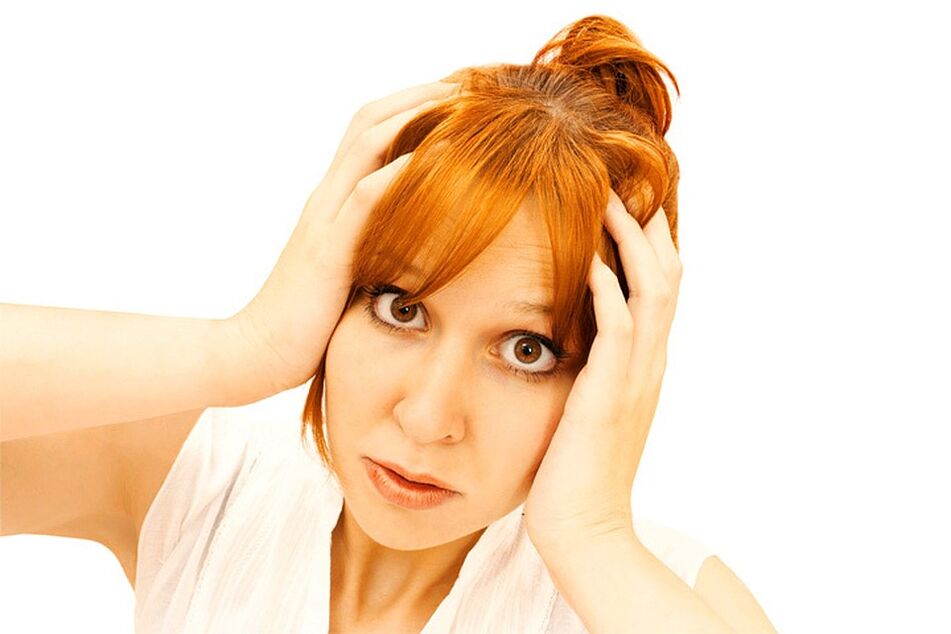 The woman holds her head